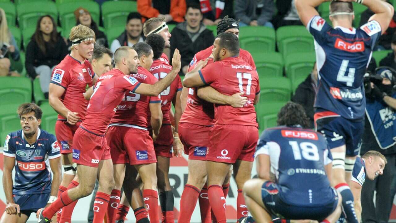 Reds players celebrate after scoring a try