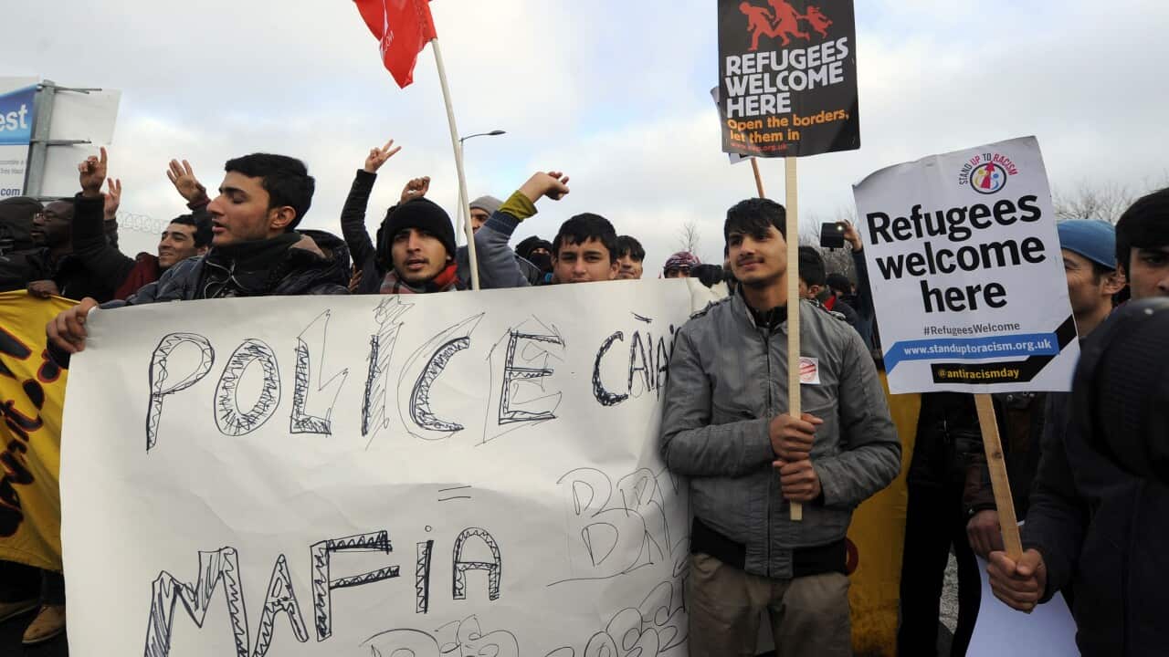 Migrants hold banners in the French port city of Calais, northern France, during a demonstration to support the migrants and refugees who live in the 'jungle', an encampment made up of migrants who are mainly trying to reach Britain.