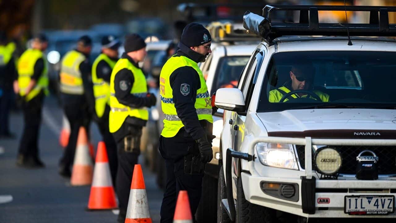 NSW Police officers check cars crossing from Victoria into New South Wales on Wednesday.