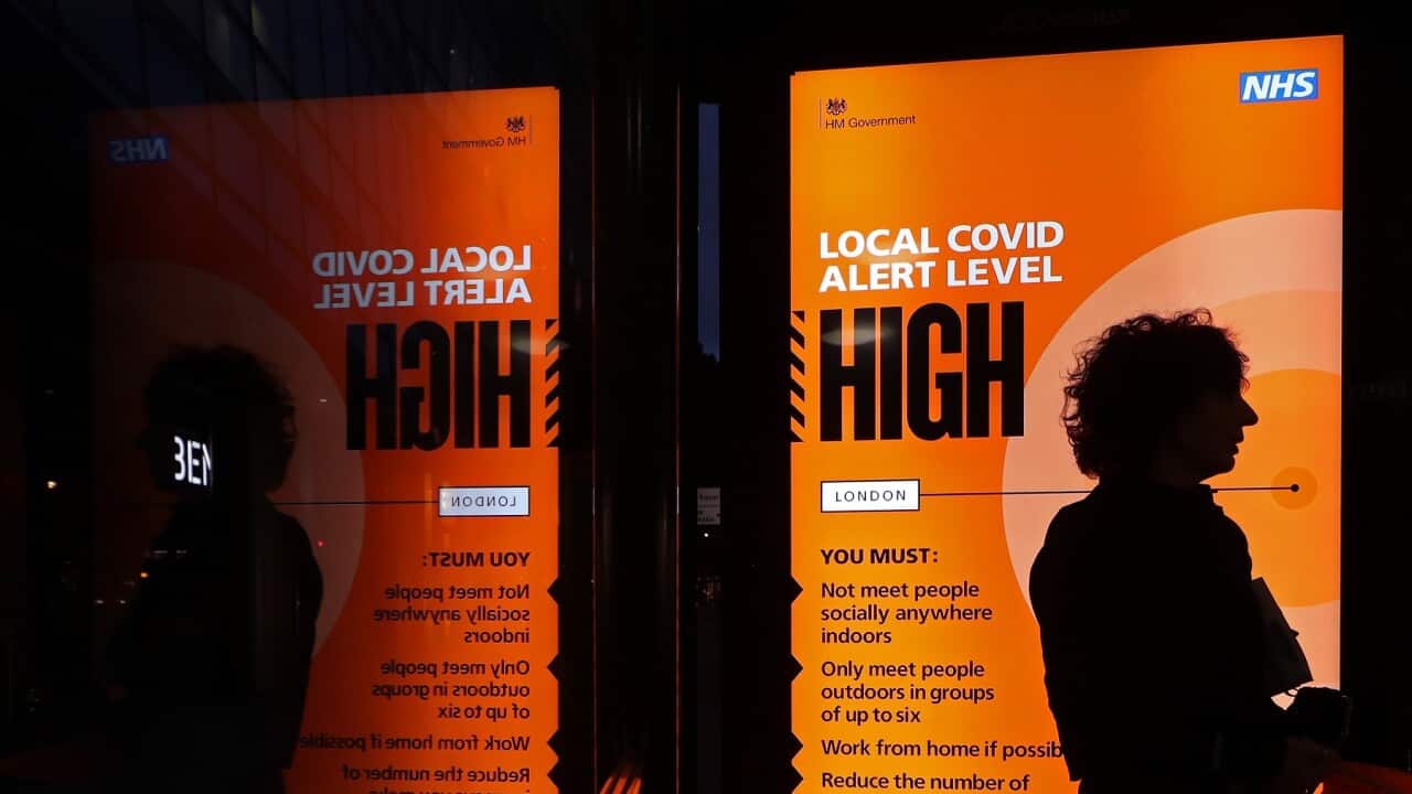 An NHS Covid high alert level sign on a bus shelter in central London