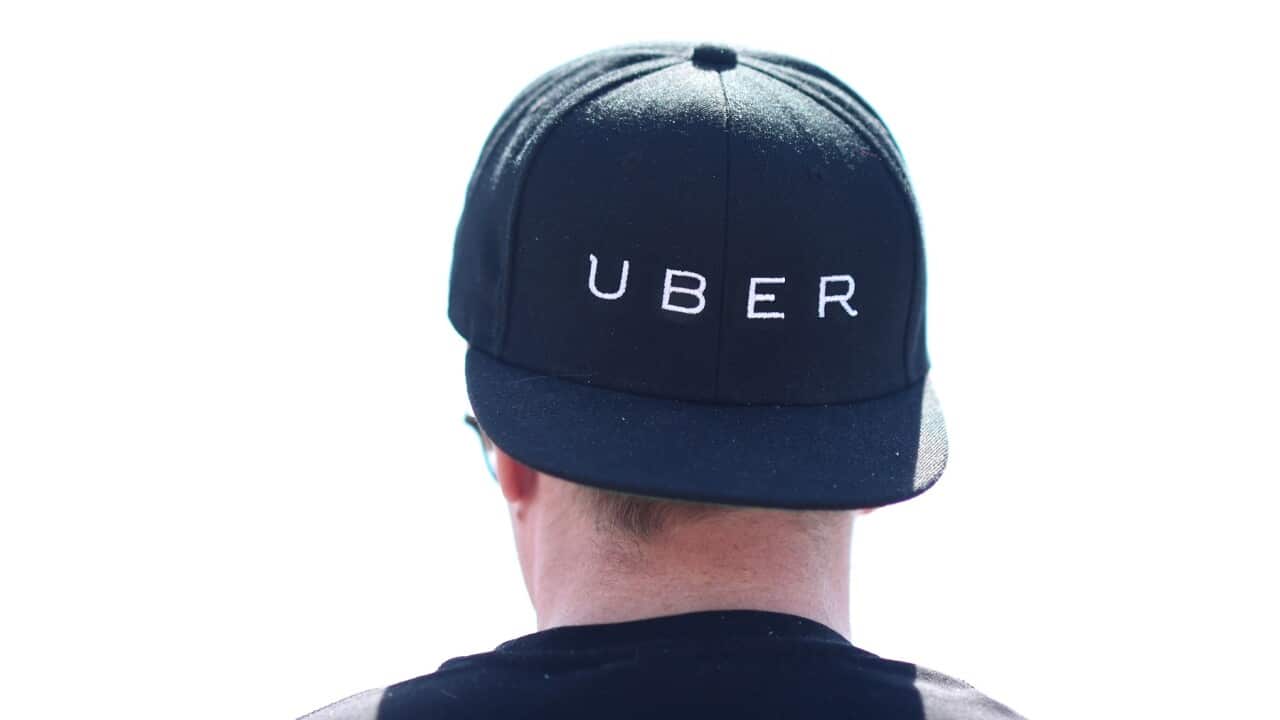 A man wearing an Uber cap