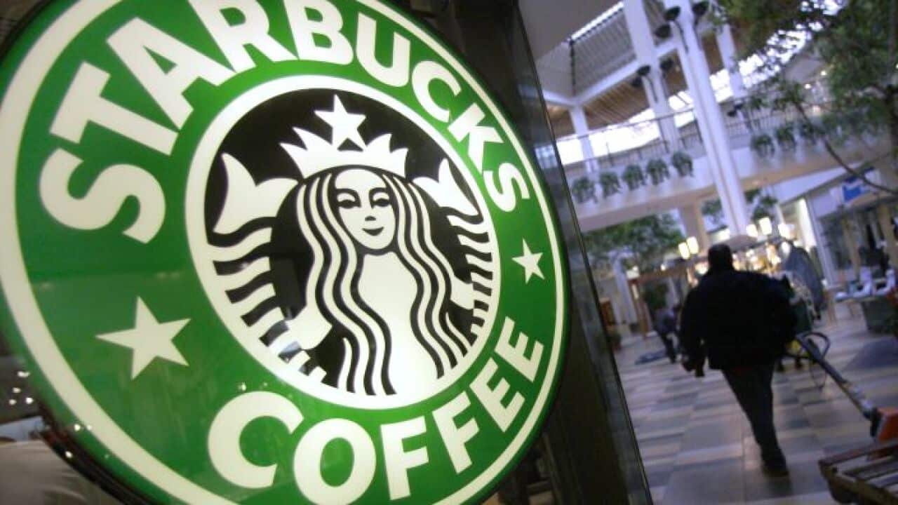Starbucks chief executive apologises for arrests of two black men, which sparked accusations of racial profiling.