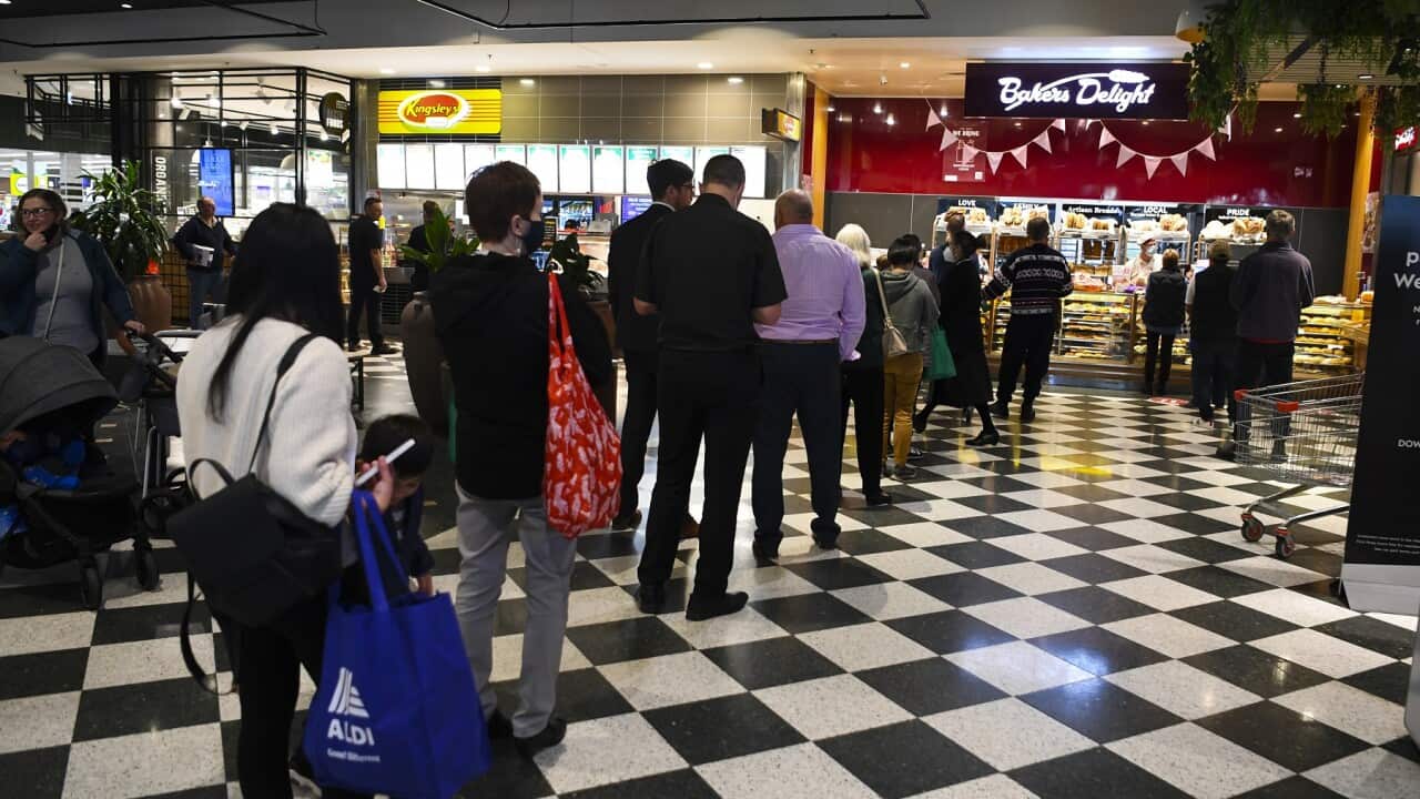 Customers queue at a bakery in Woden, Canberra following the lockdown announcement