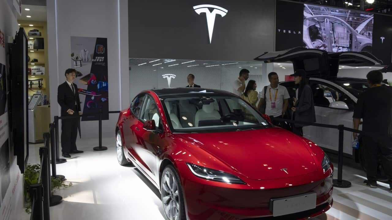 People looking at a car.