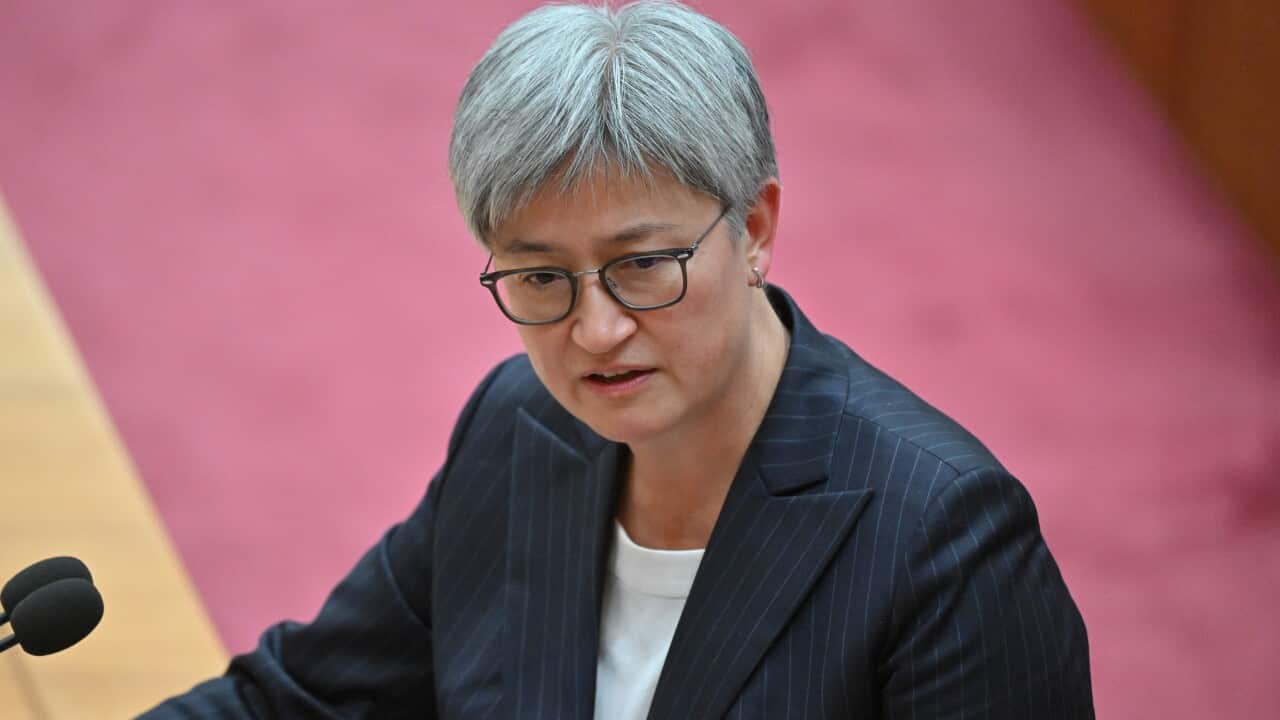 Penny Wong speaking into a microphone while in the Senate.