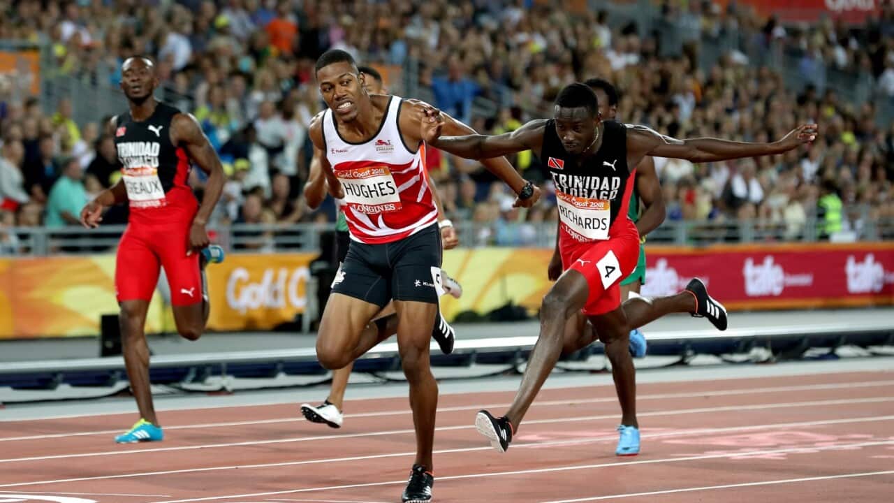 Trinidad and Tobago's Jereem Richards (right) wins the Men's 200m Final after England's Zharnel Hughes is disqualified at the Carrara Stadium 