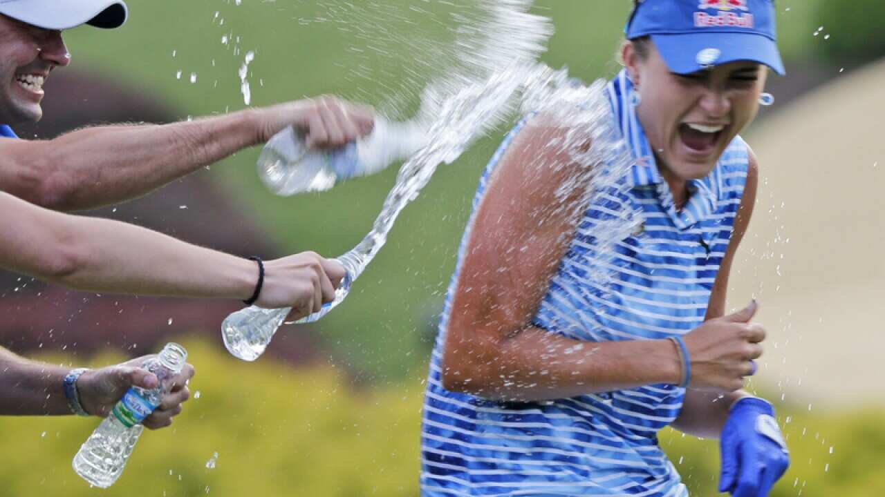 Lexi Thompson is doused with water