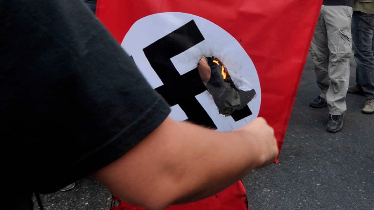 A person burning Nazi flag