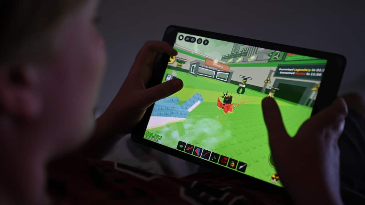A 12-year-old boy plays a Roblox game on his device in Sydney.