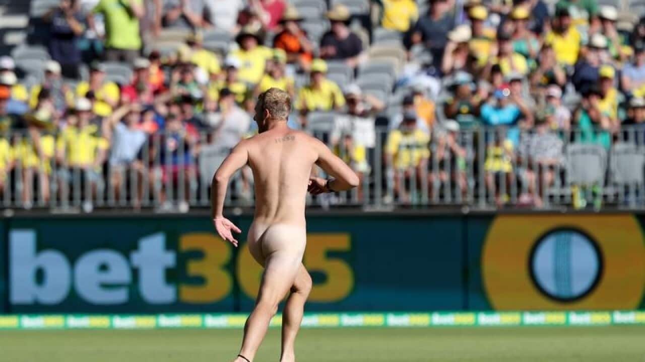 A streaker runs from security guards during the 5th ODI.