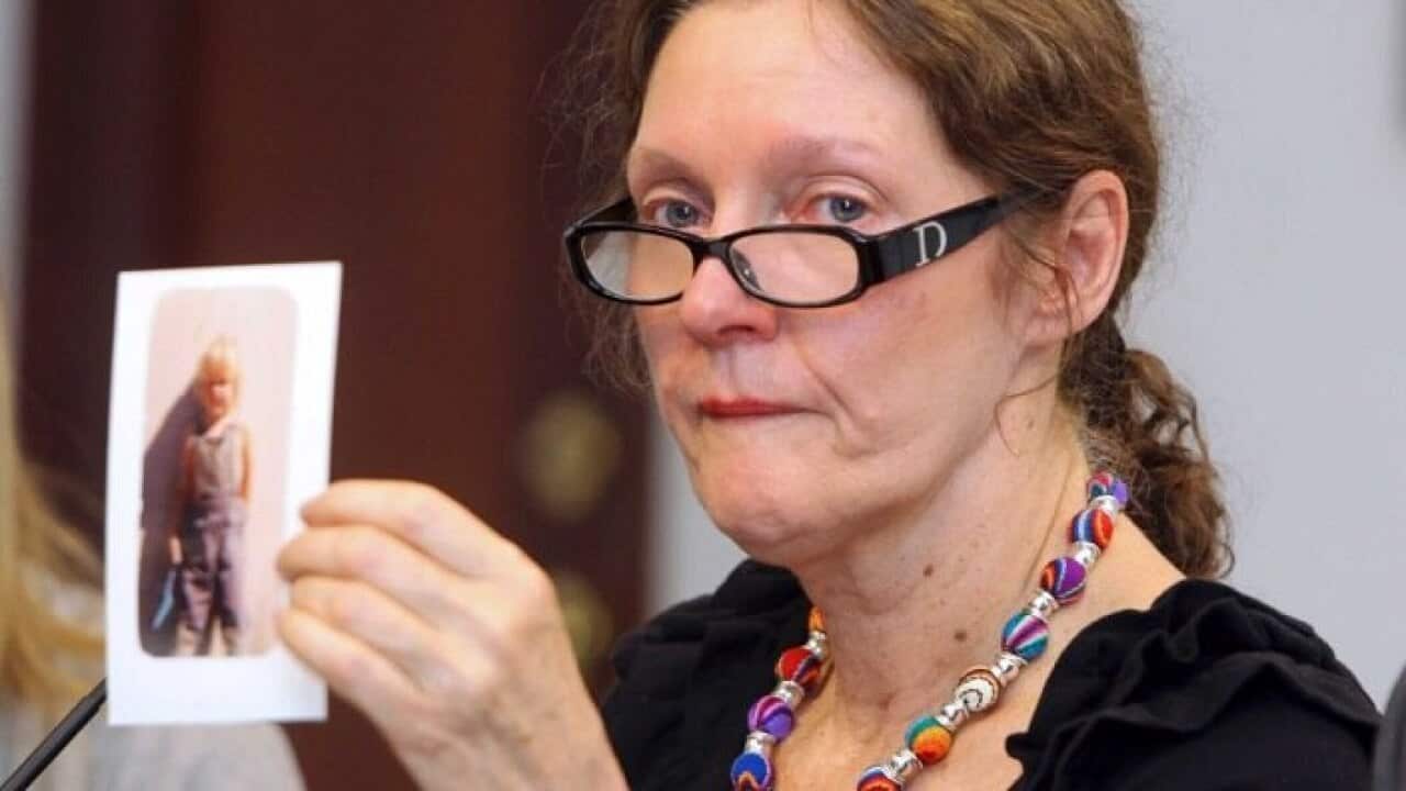 Christine Assange holds up a picture of her son when he was a child.