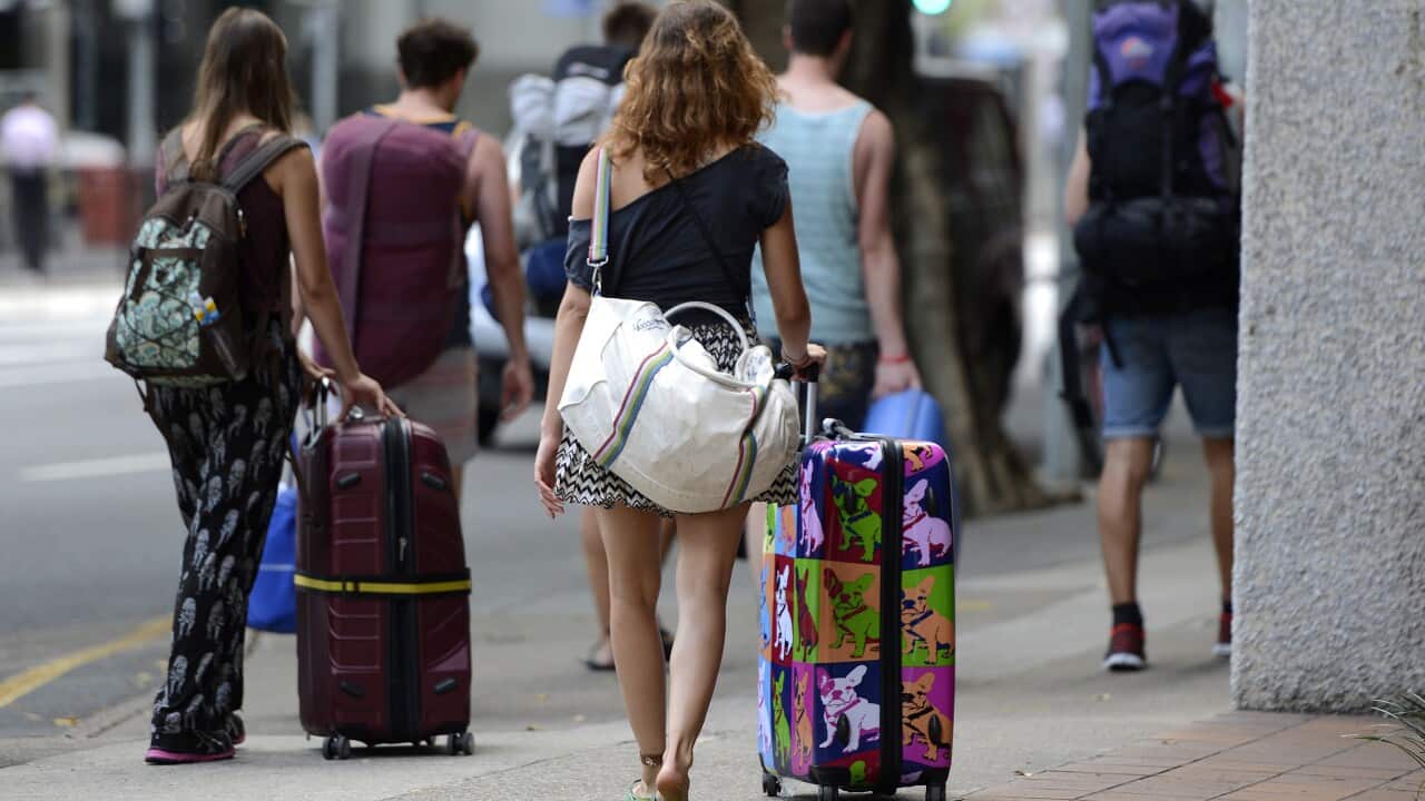 Backpackers walk through the streets of Brisbane, Wednesday, April 3, 2013. (AAP Image/Dan Peled) NO ARCHIVING
