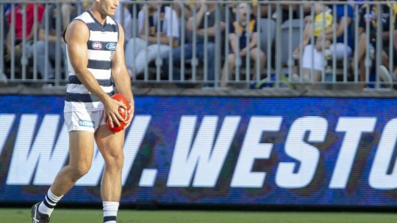 The boundary fence at Optus Stadium is seen as Tom Hawkins kicks.