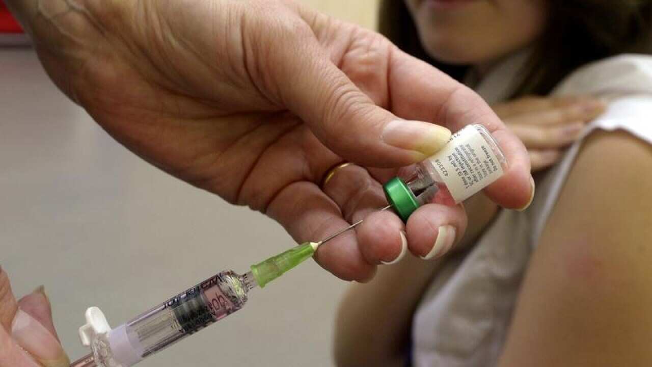 A teenager having a measles vaccination.