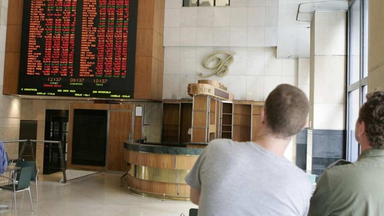 People watching the information boards as the ASX in Sydney