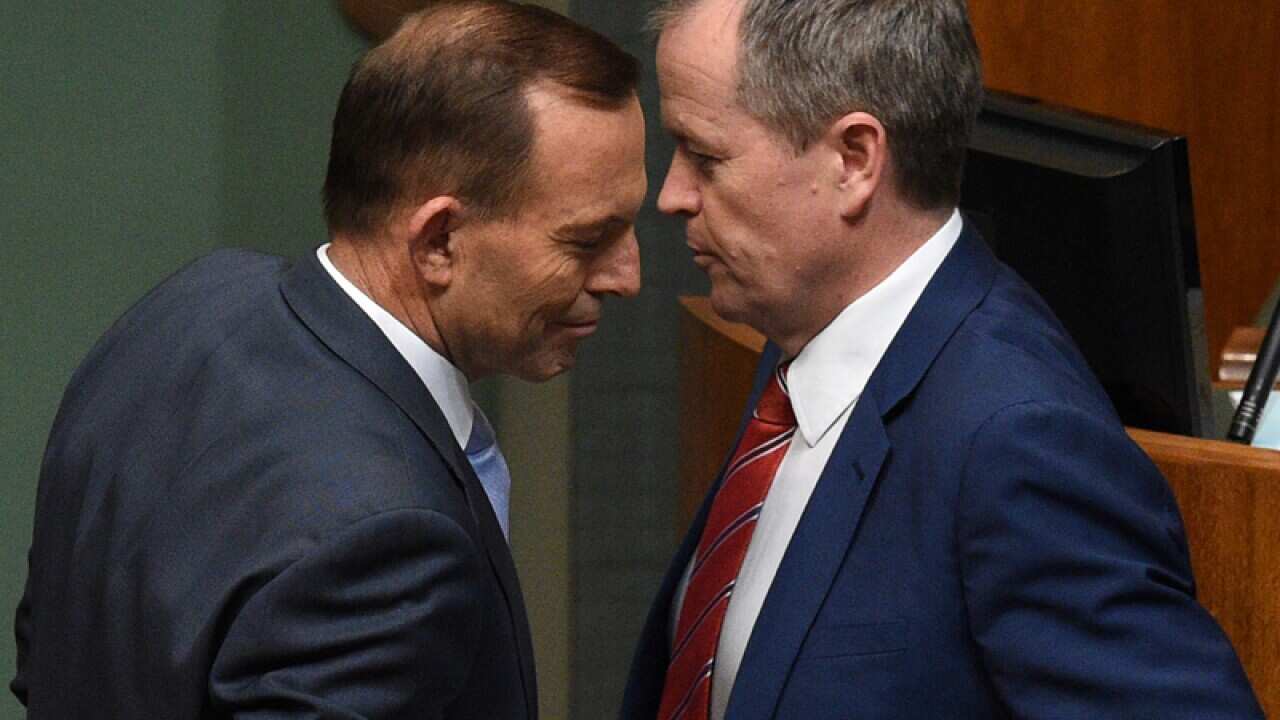 Tony Abbott (left) and Opposition Leader Bill Shorten pass each other