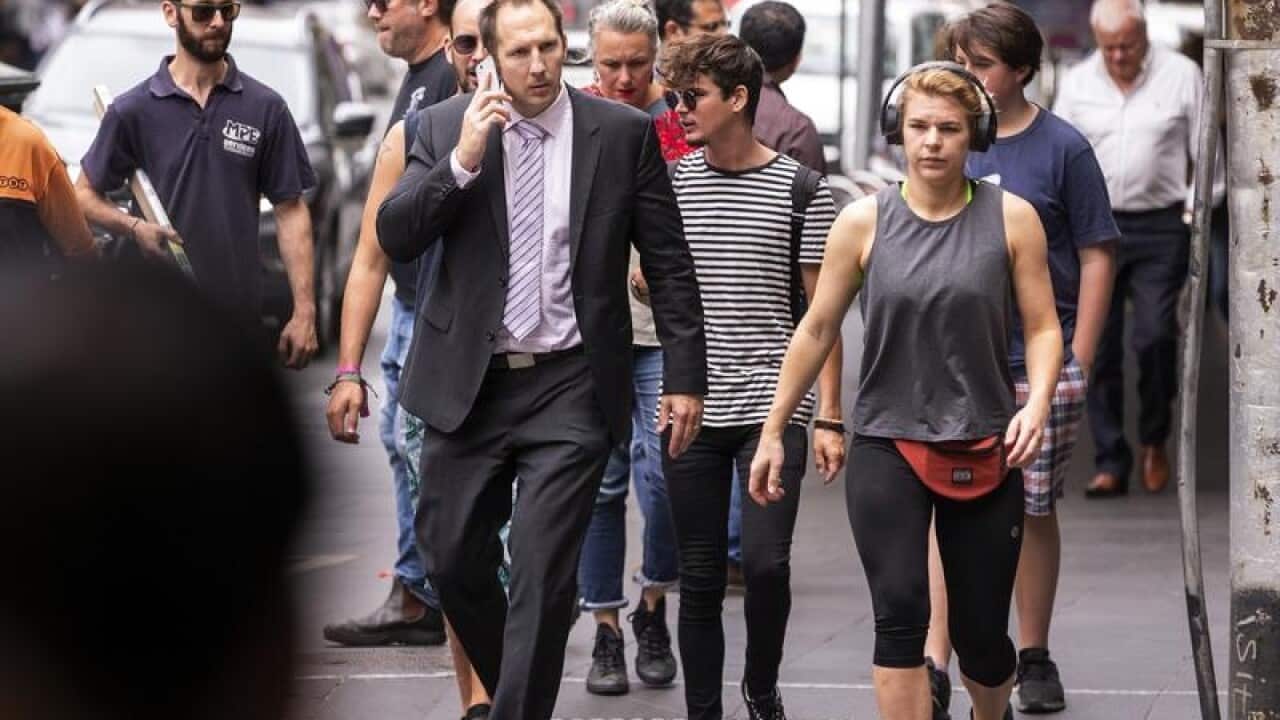 People are seen walking in the Melbourne CBD