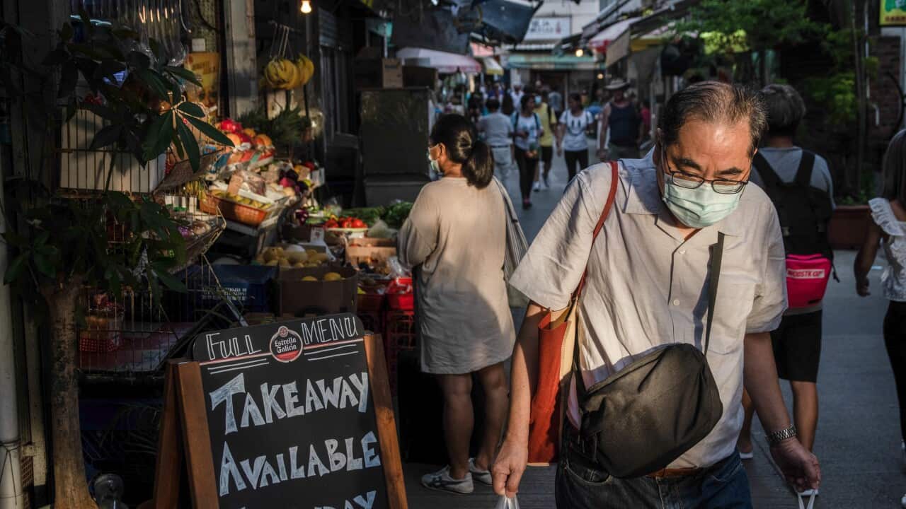 A man wearing a face mask buys takeaway food at a restaurant,Summer 2020 is marked by the scenes related to the coronavirus pandemic. Surgical masks and warnings banning people from accessing the scenario. (Photo by Ivan Abreu / SOPA Images/Sipa USA)