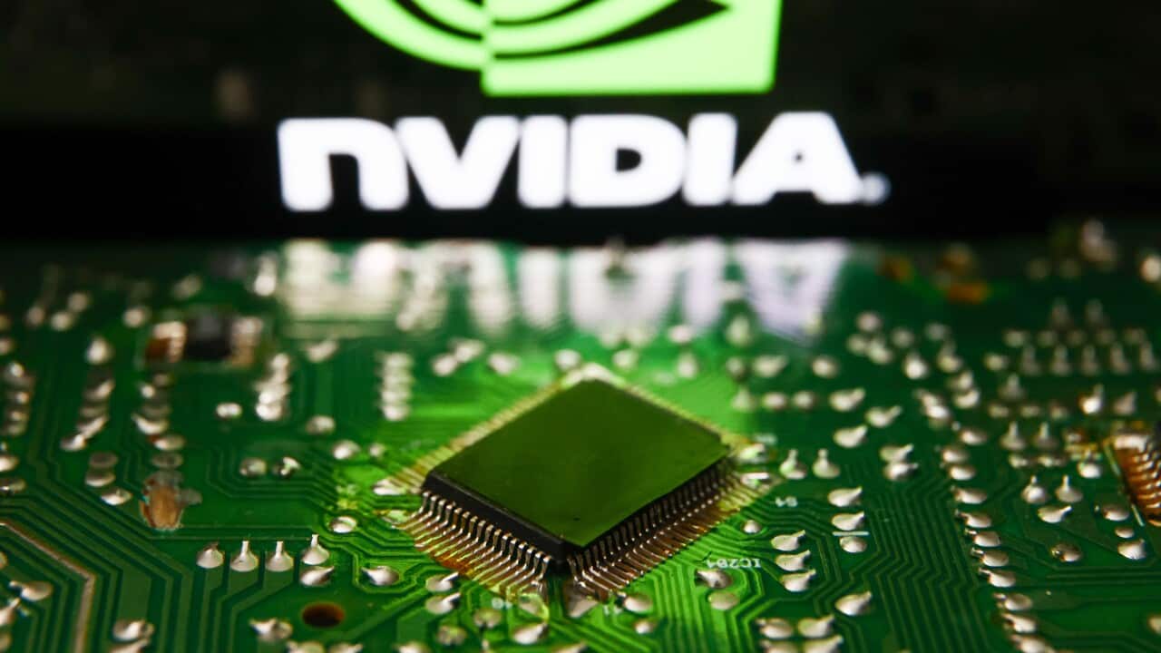 A microchip with an illuminated Nvidia logo behind it.