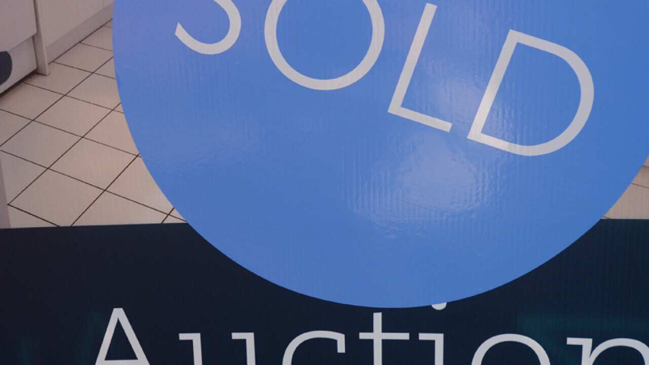 a sold sign is seen in front of a house