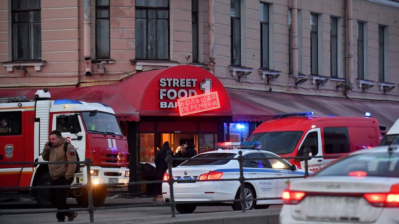 Russian police investigators at the cafe in St Petersburg where a leading Russian military blogger was killed.