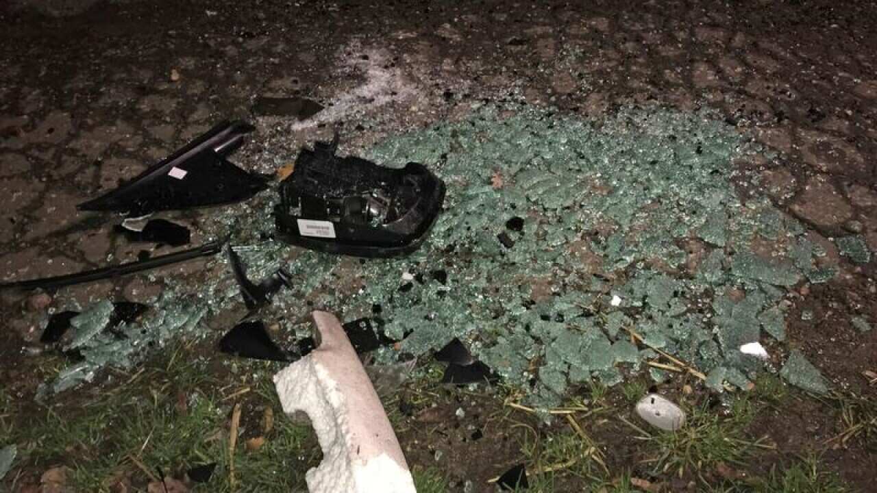 Broken glass and debris at the scene of the accident