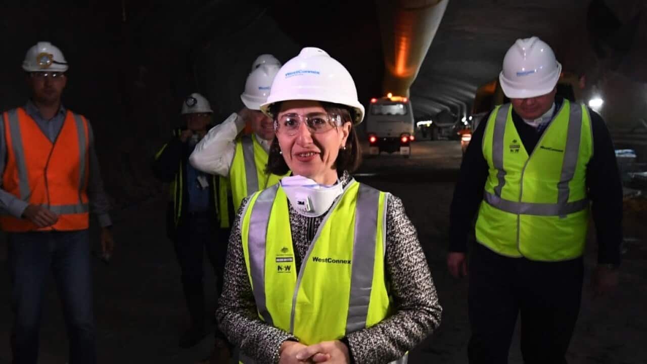 NSW Premier Gladys Berejiklian (centre) watches a roadheader and construction worker work in the eastbound WestConnex M4 tunnel on June 16 2017
