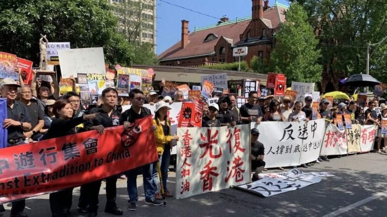 Hundreds of protesters gathered outside the Hong Kong Economic and Trade Office in Toronto on Sunday afternoon, holding large posters and chanting in unison: “Free Hong Kong!”