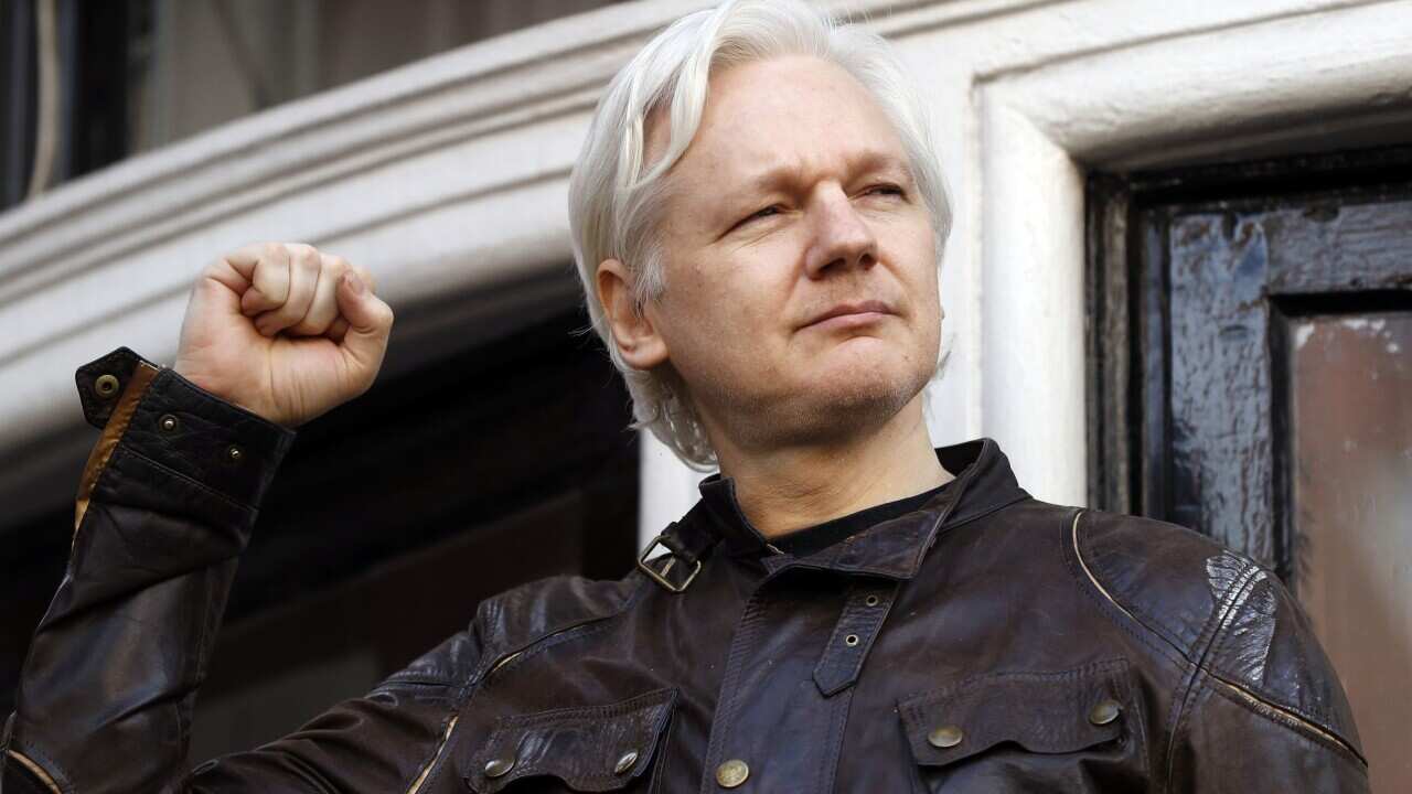 FILE - In this May 19, 2017 file photo, WikiLeaks founder Julian Assange greets supporters outside the Ecuadorian embassy in London, where he has been in self imposed exile since 2012. (AP Photo/Frank Augstein, File)