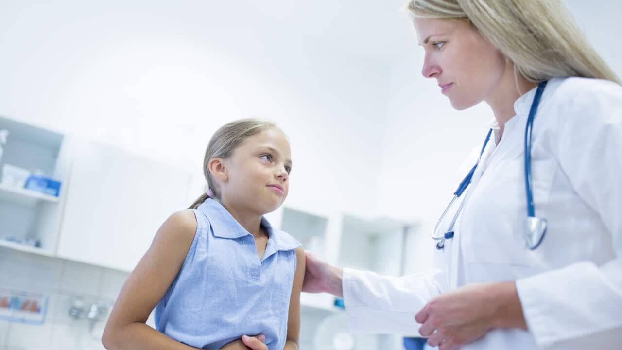 Girl clutching tummy