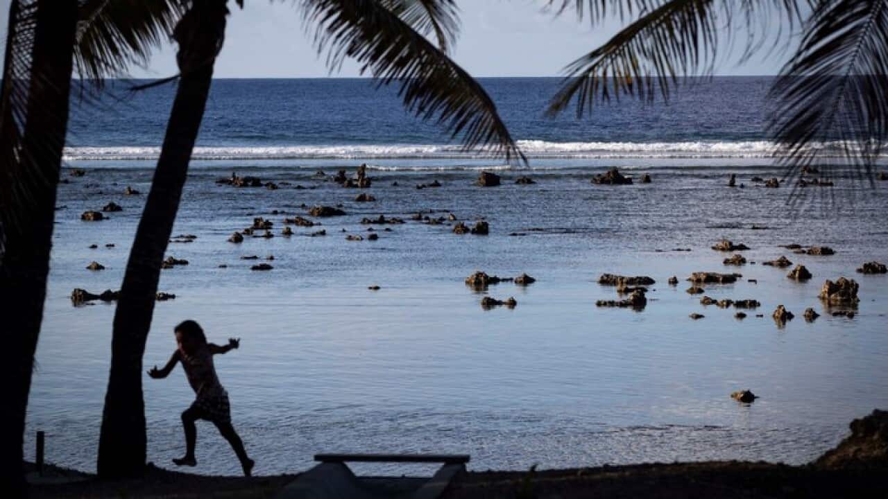 A child plays near a beach in Nauru. (AAP)