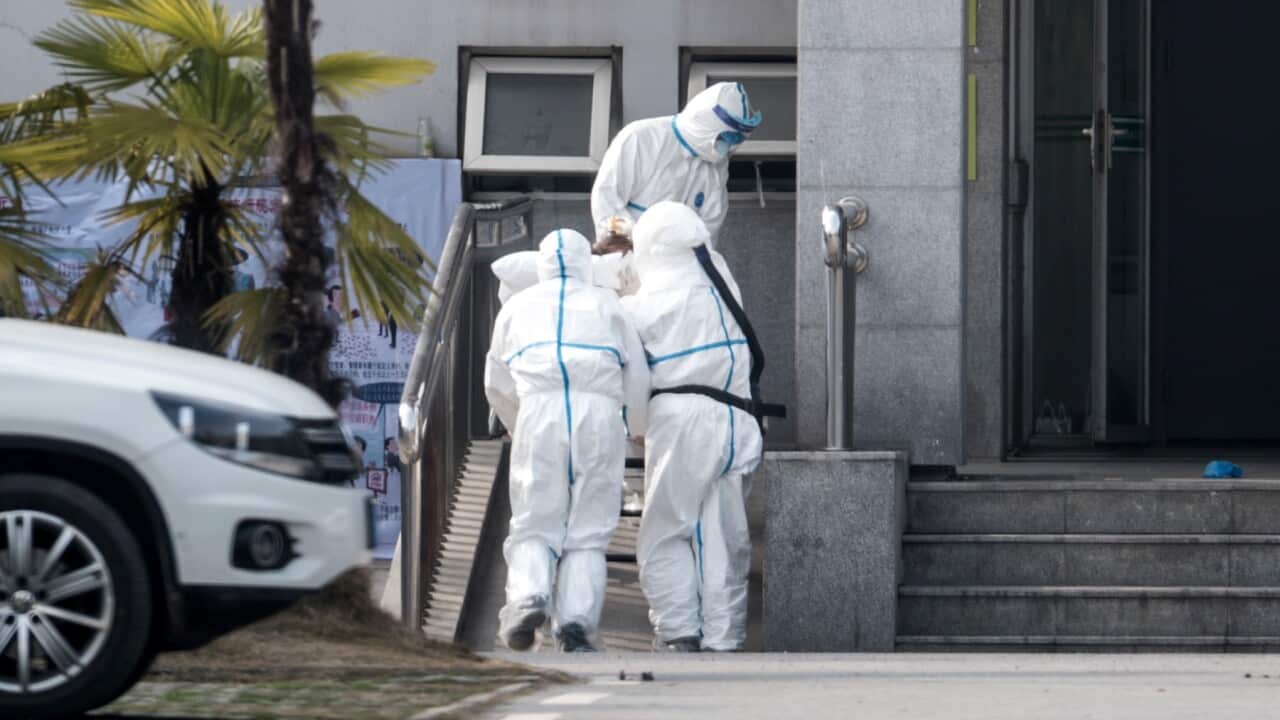 Medical staff carry a patient into the Jinyintan hospital, where patients infected with a new strain of Coronavirus.