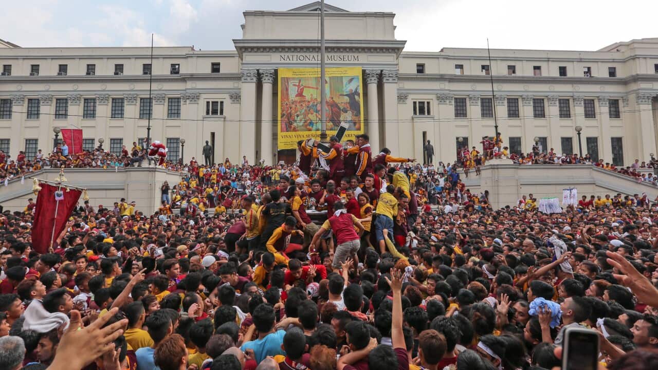 Filipino devotees jostle to reach the statue of the Black Nazarene during the procession in Manila/ (EPA)