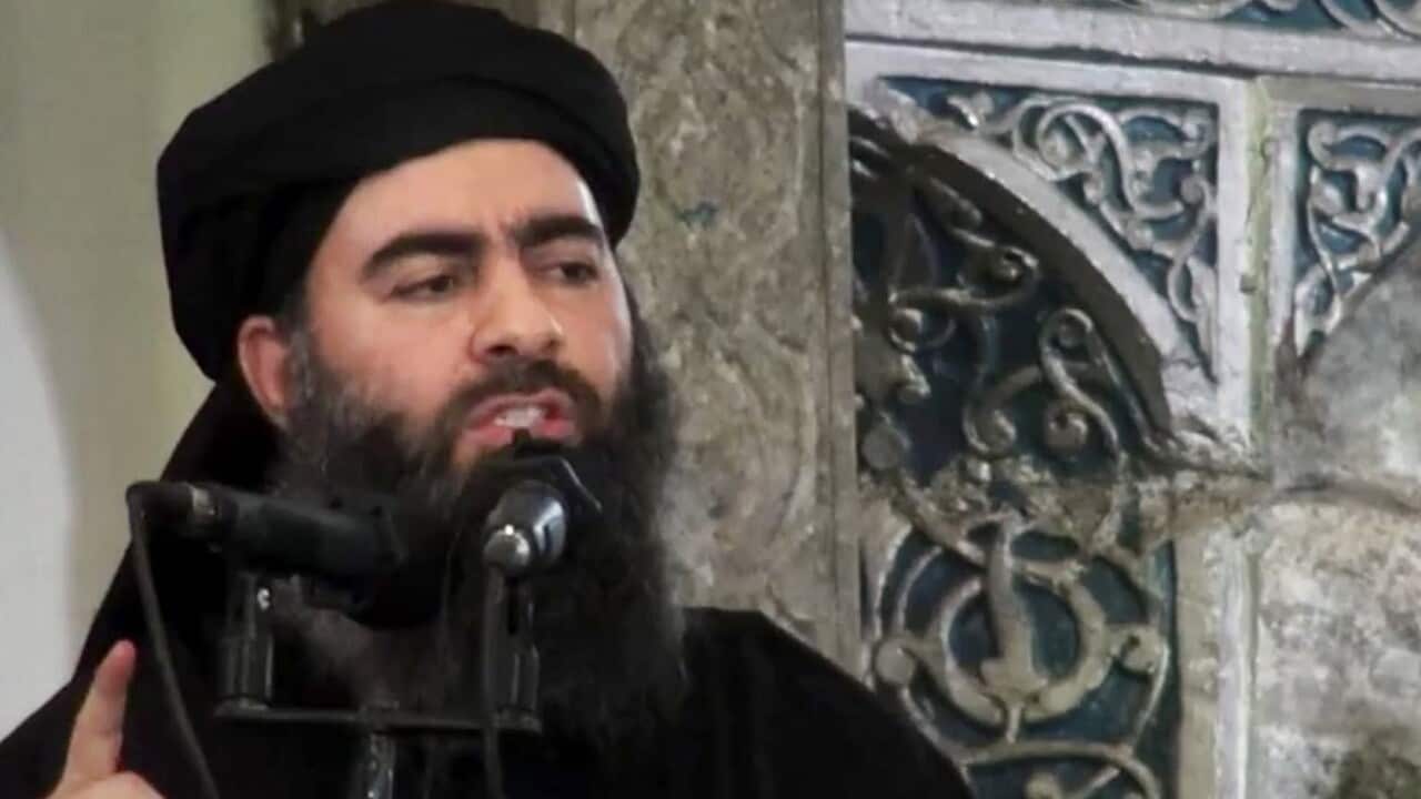 This file image from 2014 puports to Islamic State group, Abu Bakr al-Baghdadi, delivering a sermon at a mosque in Iraq.