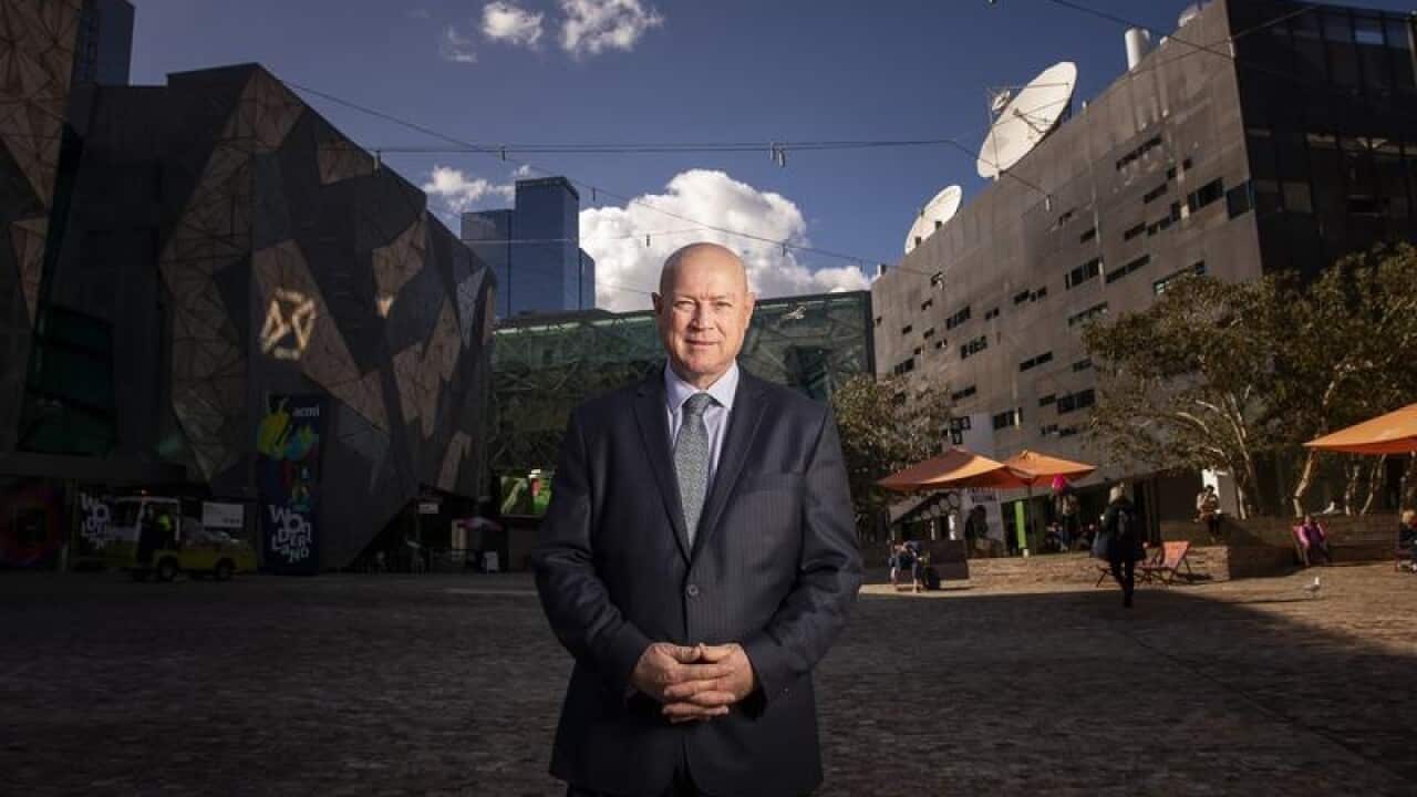 Simon Ambrose poses for a photograph at federation square.