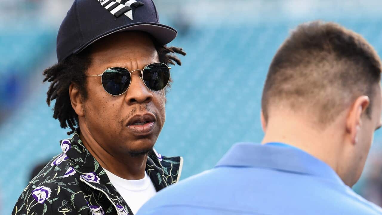 A man wearing sunglasses and a hat