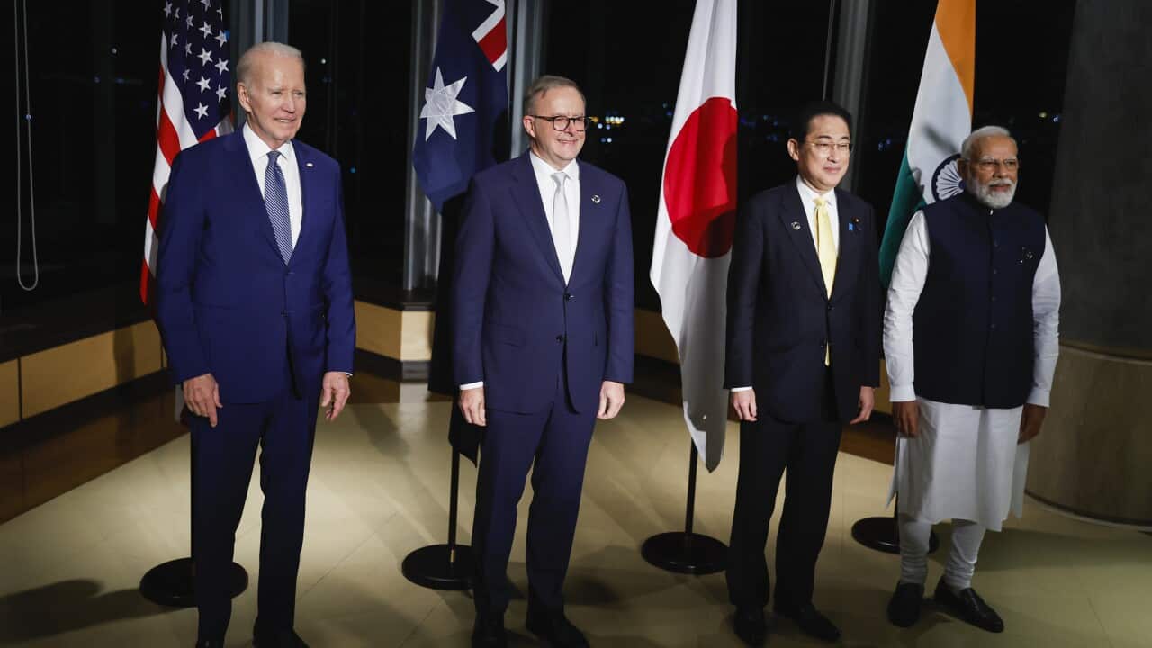 Four men posing for photos