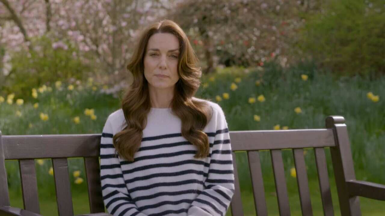 a woman sitting on a park bench