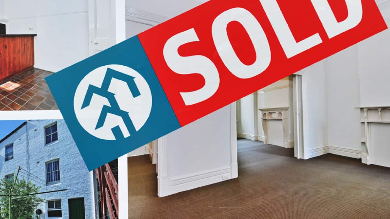 A sold sticker adorns a real estate sign in Sydney