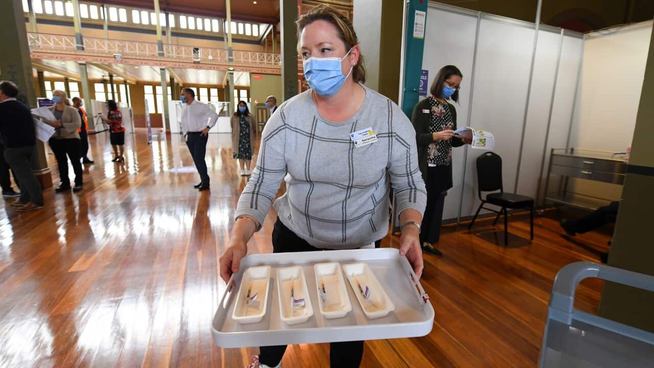 A healthcare worker transporting covid19 vaccinations to injecting rooms inside of the Royal Exhibition Building in Melbourne, Monday, March 22, 2021