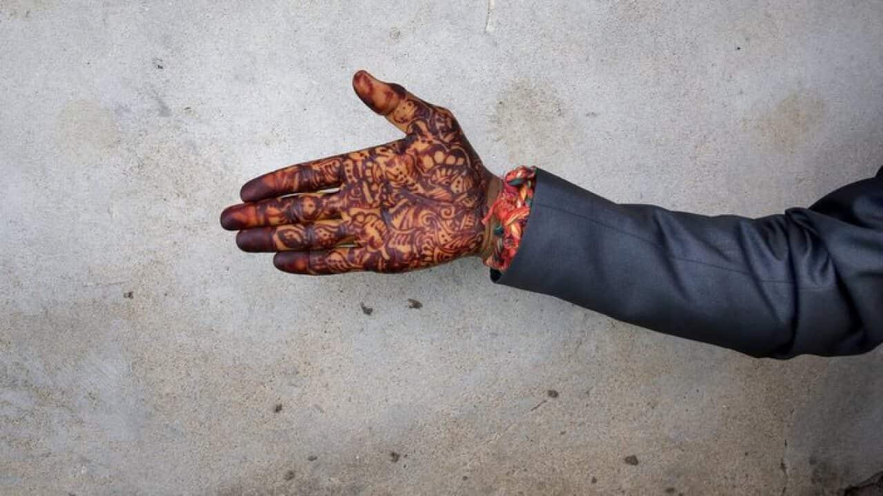 An Indian bridegroom's henna-decorated hand