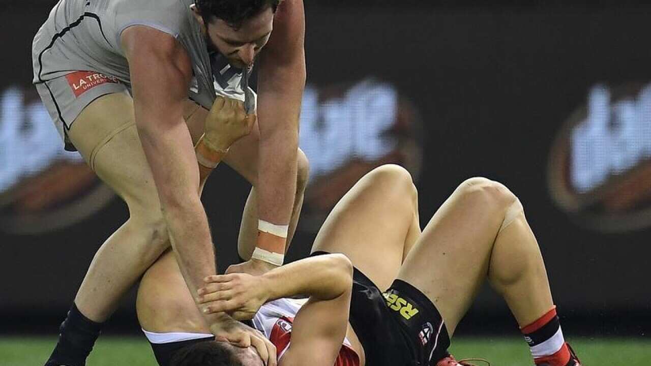 Blues Jed Lamb attempts to eye-gauge Jade Gresham of the Saints.