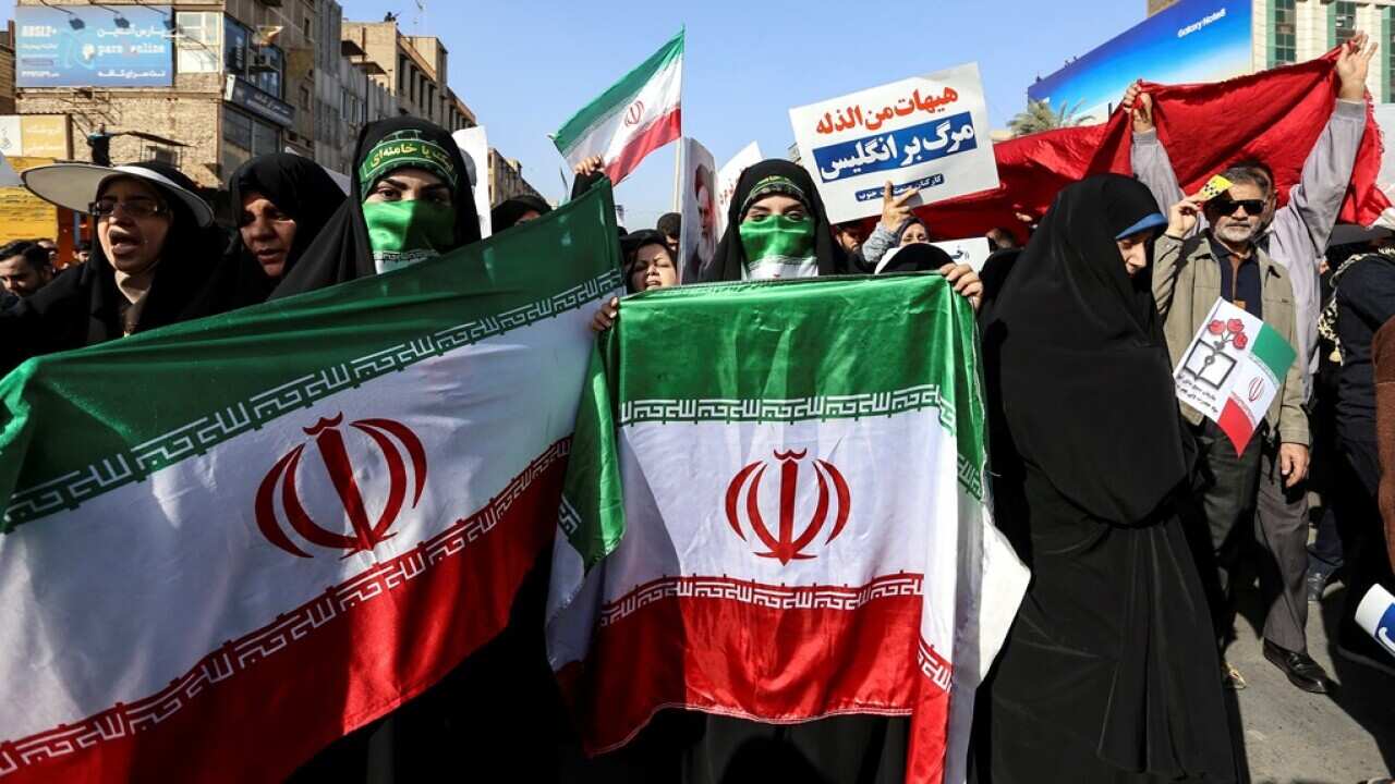 Iranian women hold Iran national flags