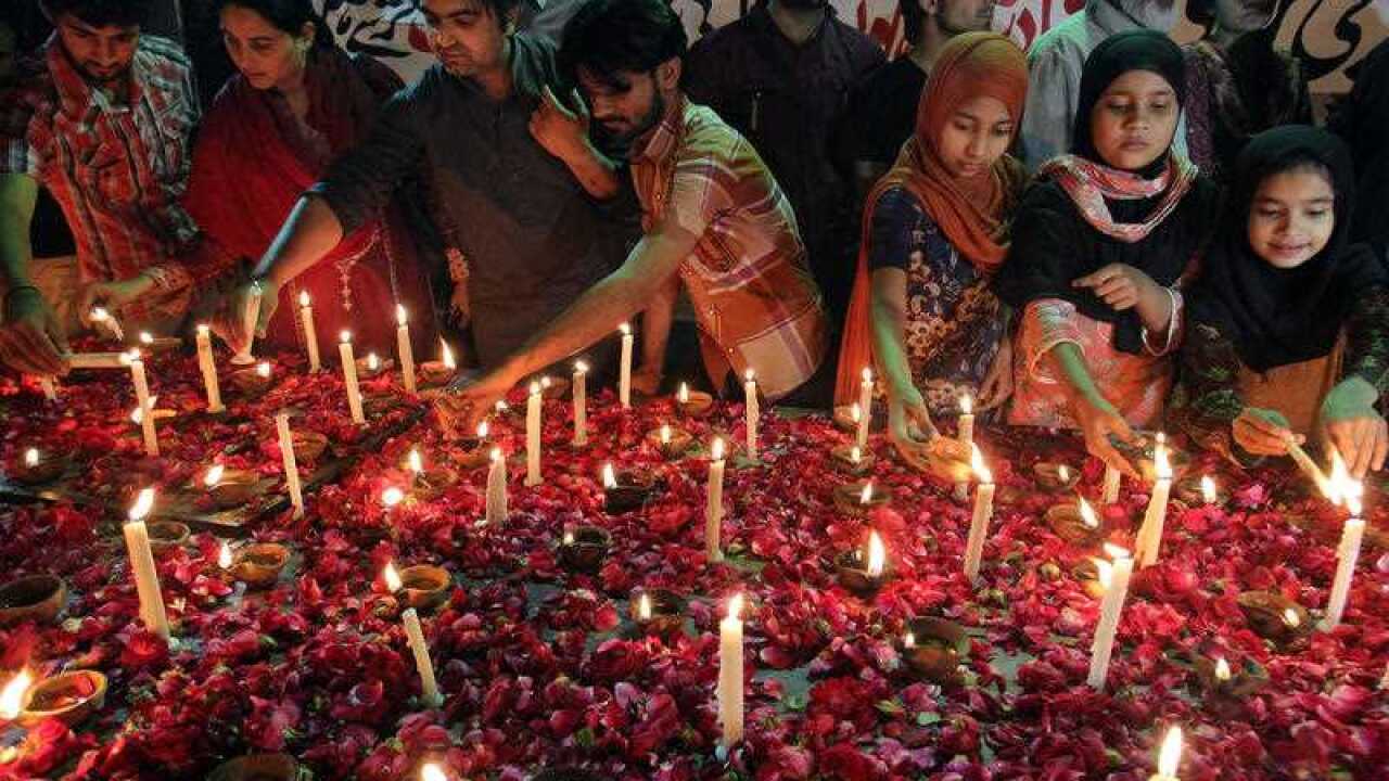 Pakistani children and members of a civil society light candles during a vigil for the victims of a suicide bombing attack on churches, Sunday, March 15, 2015 in Karachi, Pakistan. (AAP)