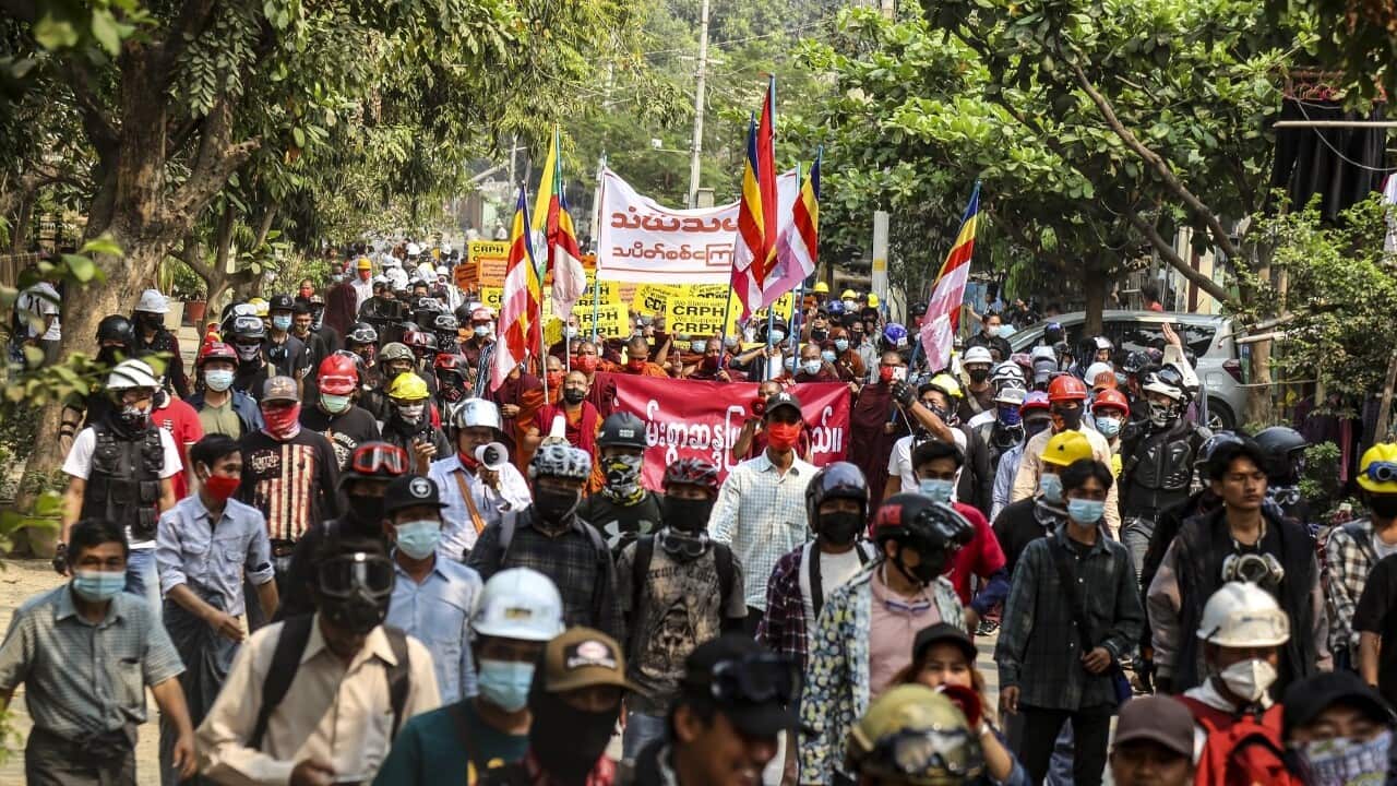 monstrators carry placards during a protest against the military coup in Myanmar (AAP).jpg