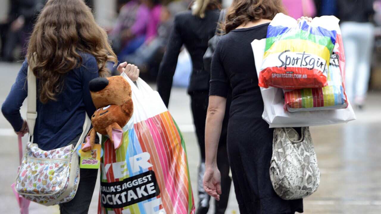 Consumers with shopping bags.