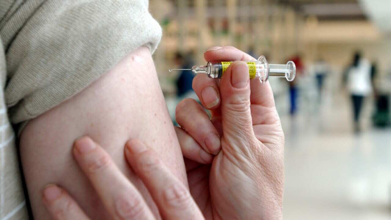 A person receiving a flu shot (AAP)