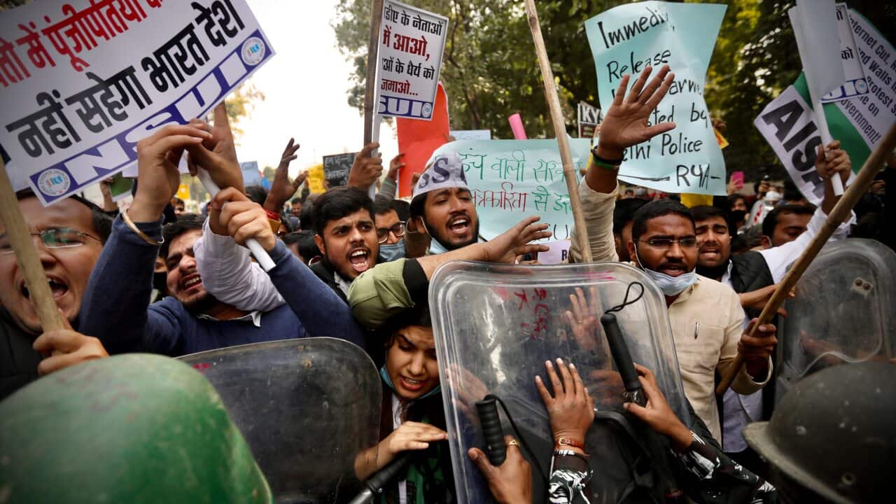 Officers push people back during a protest on 3 February in support of farmers who've been on a months-long protest in New Delhi, India.