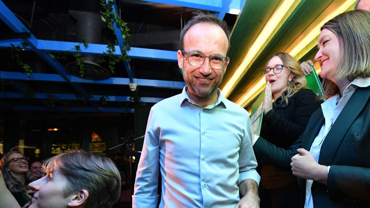 Australian Greens leader Adam Bandt exits from the stage after addressing supporters at a reception on federal election night in Melbourne.