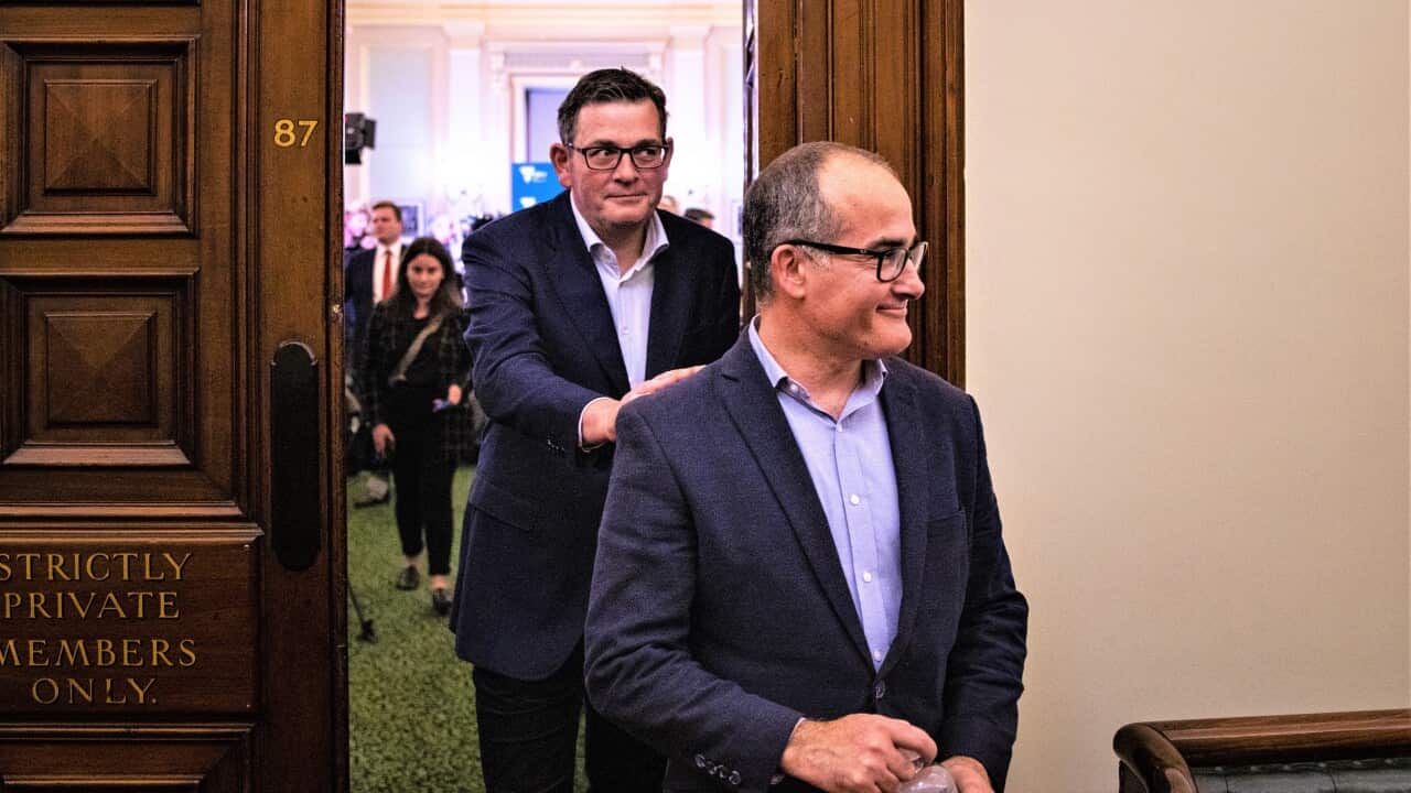Victorian Premier Daniel Andrews (centre) and Former Deputy Premier of Victoria James Merlino leave the Caucus room after a press conference at Parliament House in Melbourne, Friday, June 24, 2022. (AAP Image/Diego Fedele) NO ARCHIVING